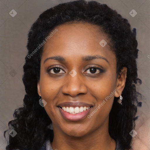 Joyful black young-adult female with long  black hair and brown eyes