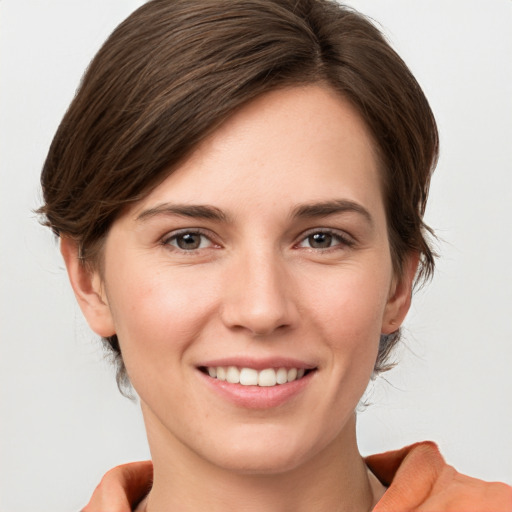 Joyful white young-adult female with short  brown hair and grey eyes