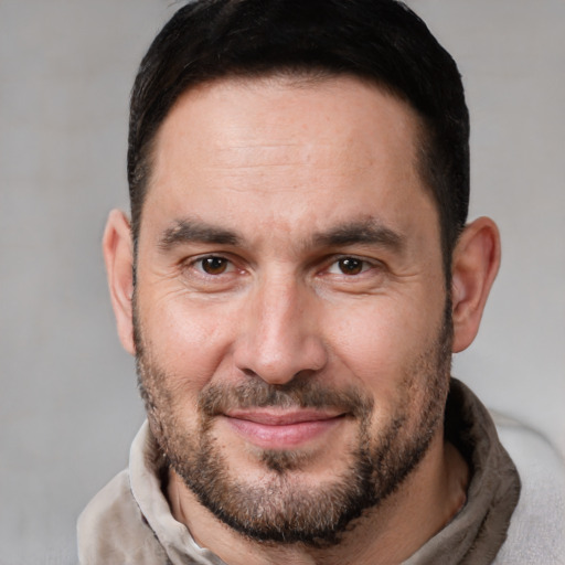 Joyful white adult male with short  brown hair and brown eyes