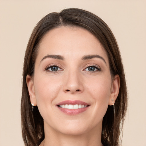 Joyful white young-adult female with long  brown hair and grey eyes