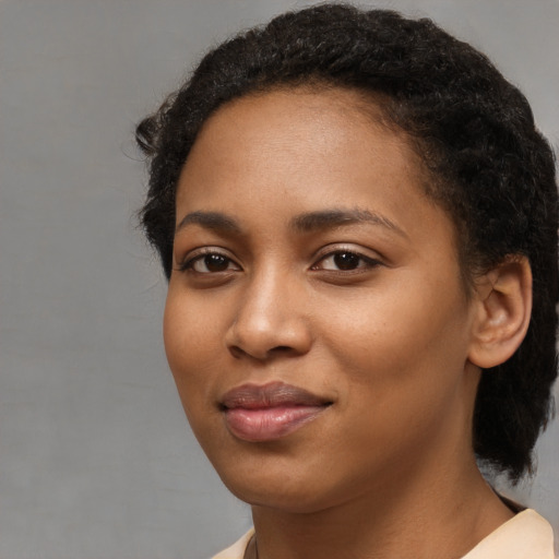 Joyful black young-adult female with medium  brown hair and brown eyes