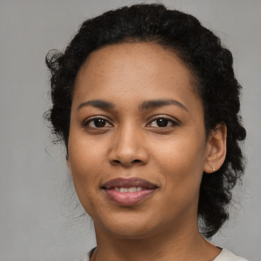 Joyful latino young-adult female with medium  black hair and brown eyes