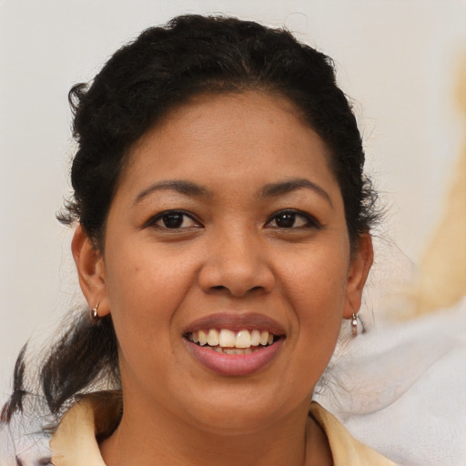 Joyful latino young-adult female with medium  brown hair and brown eyes