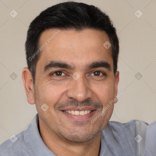 Joyful white adult male with short  black hair and brown eyes