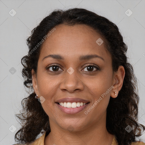 Joyful black young-adult female with medium  brown hair and brown eyes