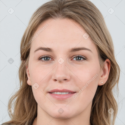 Joyful white young-adult female with long  brown hair and blue eyes