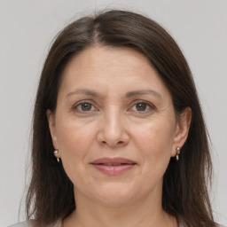 Joyful white adult female with medium  brown hair and grey eyes