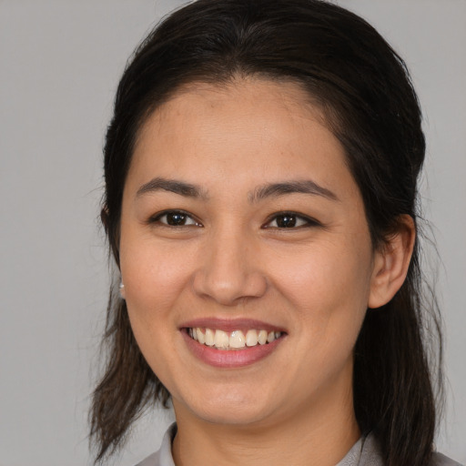 Joyful asian young-adult female with medium  brown hair and brown eyes
