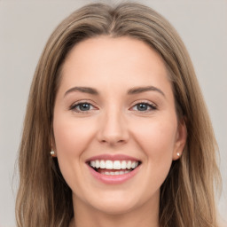 Joyful white young-adult female with long  brown hair and green eyes