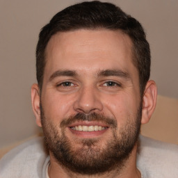 Joyful white adult male with short  brown hair and brown eyes