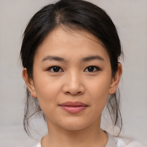 Joyful asian young-adult female with medium  brown hair and brown eyes