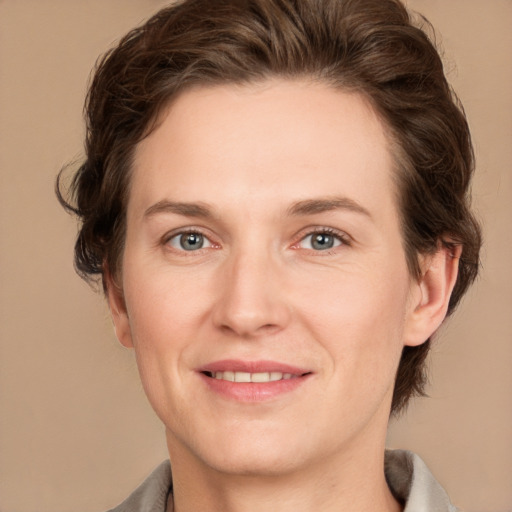 Joyful white adult female with medium  brown hair and grey eyes