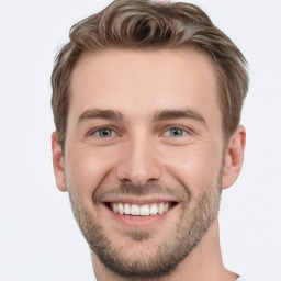 Joyful white young-adult male with short  brown hair and grey eyes