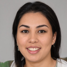 Joyful latino young-adult female with medium  brown hair and brown eyes