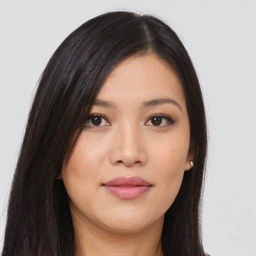 Joyful asian young-adult female with long  brown hair and brown eyes