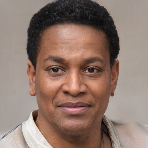Joyful latino adult male with short  brown hair and brown eyes