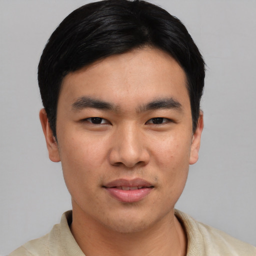 Joyful asian young-adult male with short  black hair and brown eyes