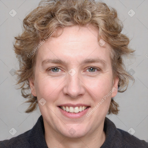 Joyful white adult female with medium  brown hair and blue eyes