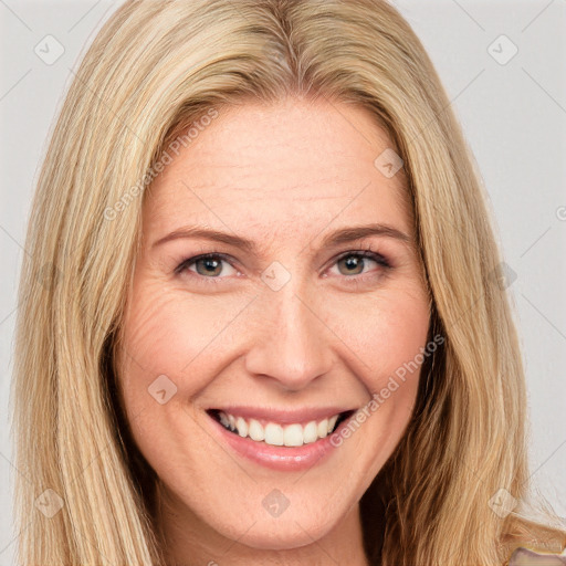 Joyful white adult female with long  brown hair and brown eyes