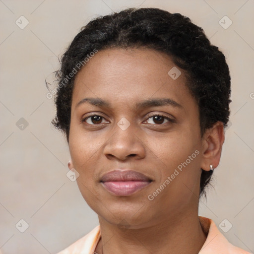 Joyful black young-adult female with short  black hair and brown eyes