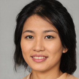 Joyful asian young-adult female with medium  brown hair and brown eyes