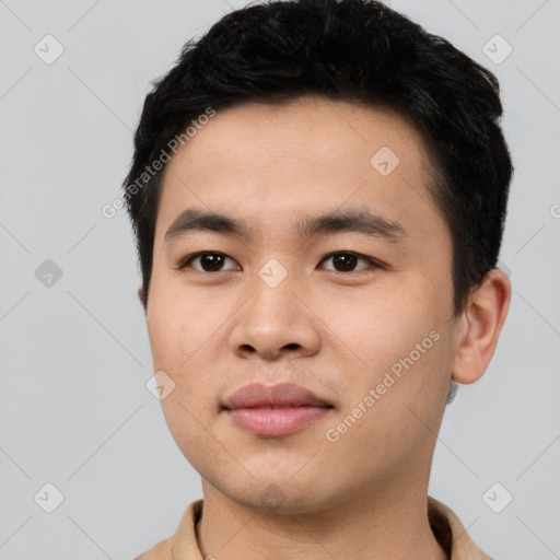 Joyful asian young-adult male with short  black hair and brown eyes