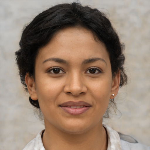 Joyful latino young-adult female with short  brown hair and brown eyes