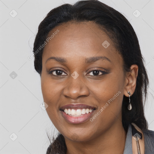 Joyful black young-adult female with long  brown hair and brown eyes