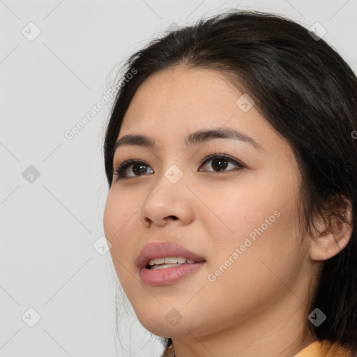 Joyful asian young-adult female with long  black hair and brown eyes