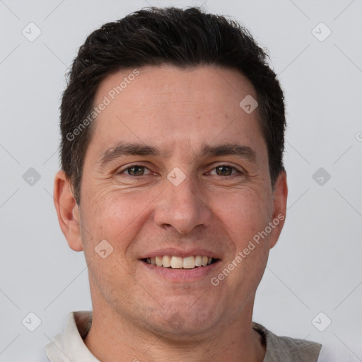 Joyful white adult male with short  brown hair and brown eyes