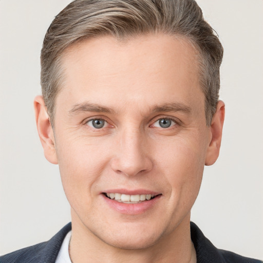 Joyful white adult male with short  brown hair and grey eyes