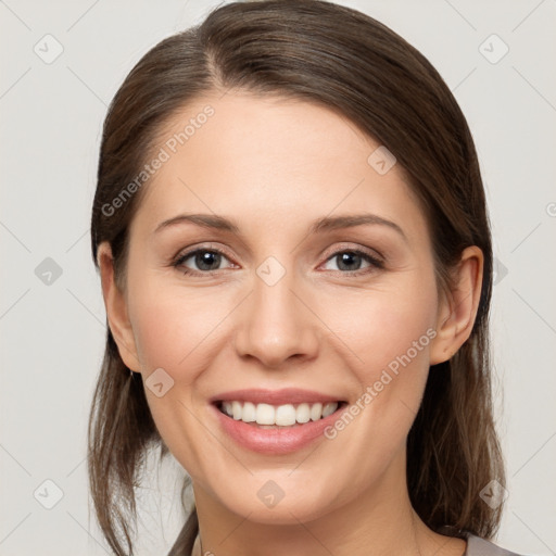 Joyful white young-adult female with medium  brown hair and grey eyes