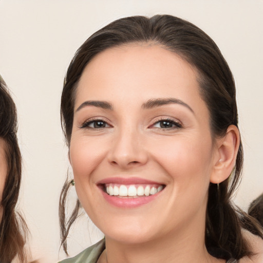 Joyful white young-adult female with medium  brown hair and brown eyes