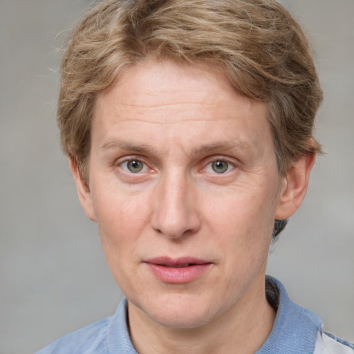 Joyful white adult male with short  brown hair and blue eyes