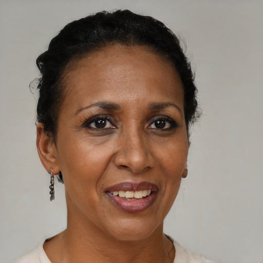 Joyful black adult female with short  brown hair and brown eyes