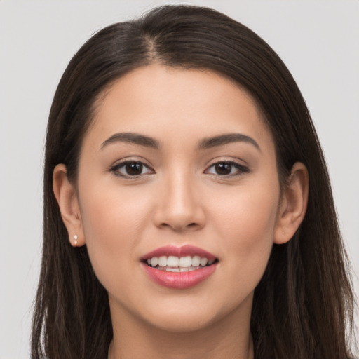 Joyful white young-adult female with long  brown hair and brown eyes