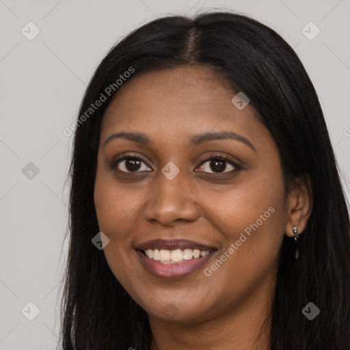 Joyful black young-adult female with long  brown hair and brown eyes