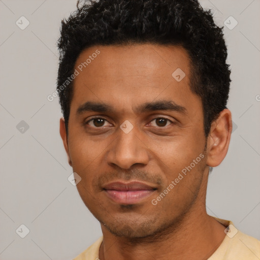 Joyful black young-adult male with short  black hair and brown eyes