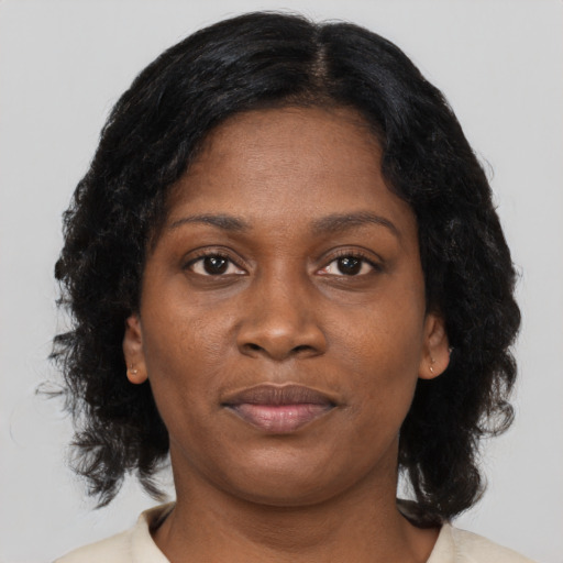 Joyful black young-adult female with medium  brown hair and brown eyes