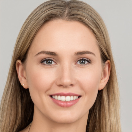 Joyful white young-adult female with long  brown hair and grey eyes