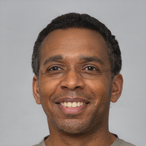 Joyful latino adult male with short  black hair and brown eyes