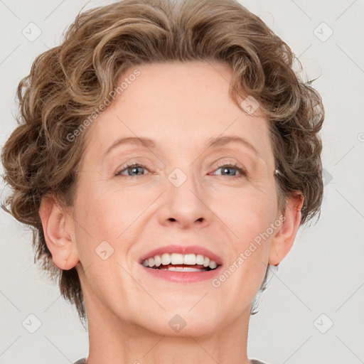 Joyful white adult female with medium  brown hair and blue eyes