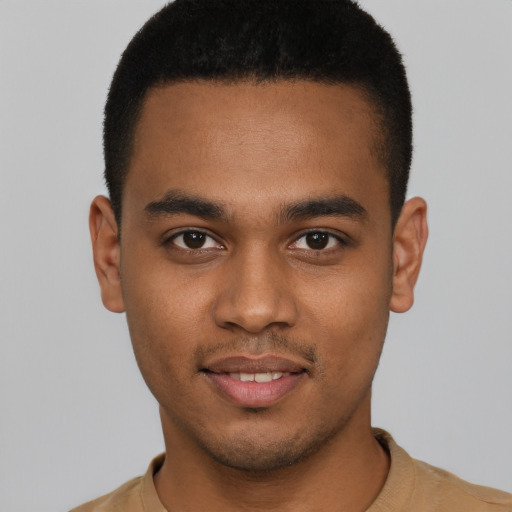 Joyful black young-adult male with short  brown hair and brown eyes