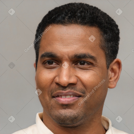 Joyful latino adult male with short  black hair and brown eyes