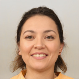 Joyful white young-adult female with medium  brown hair and brown eyes