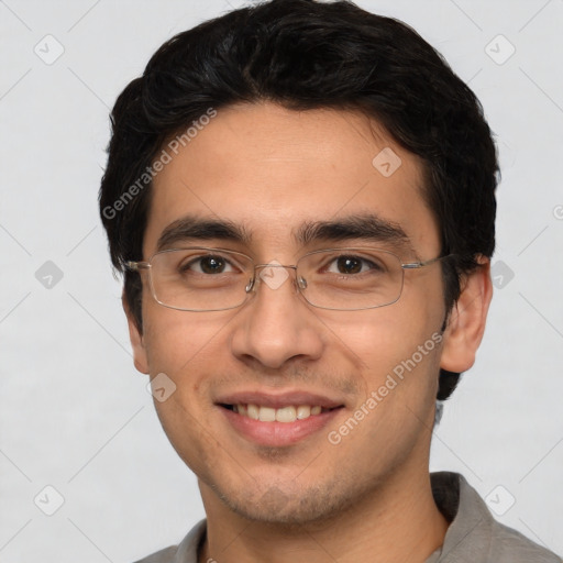 Joyful white young-adult male with short  black hair and brown eyes