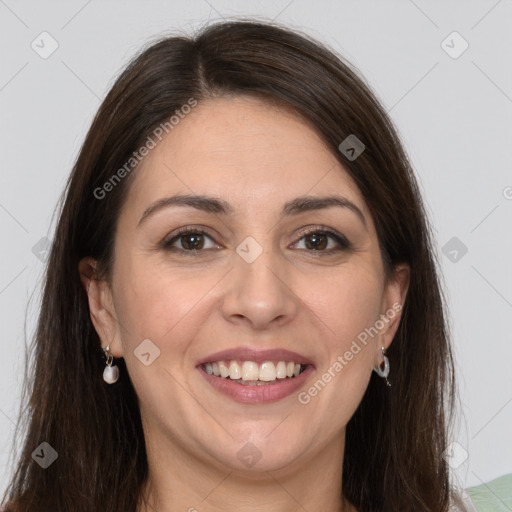 Joyful white adult female with long  brown hair and grey eyes