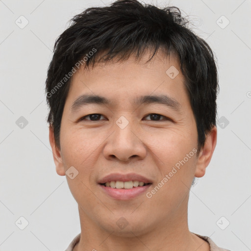 Joyful asian young-adult male with short  brown hair and brown eyes