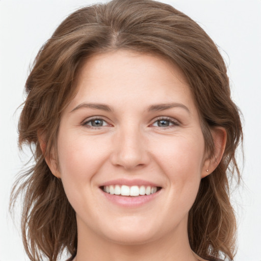 Joyful white young-adult female with long  brown hair and grey eyes