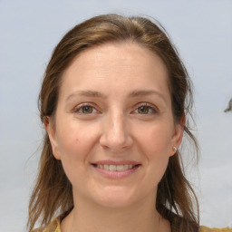 Joyful white adult female with medium  brown hair and brown eyes